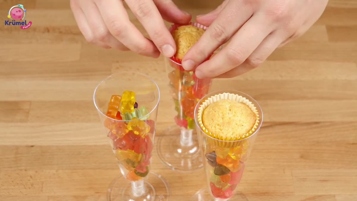 Party Cupcakes: Bunte Muffins im Sektglas für Karneval - Einweg-Sektgläser mit Gummibärchen füllen.
